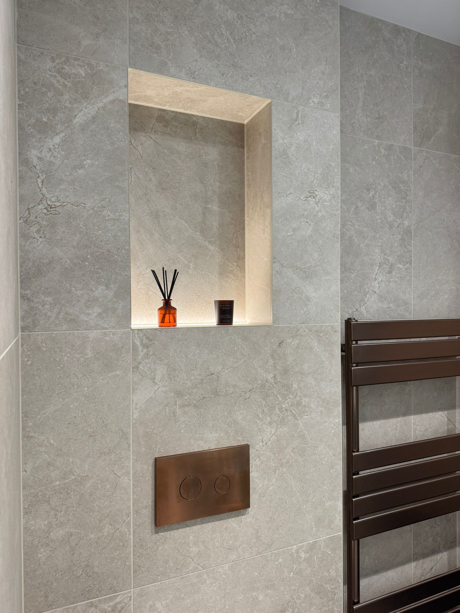 Large format stone tiles with lit niche — completed bathroom by SW Wall & Floor Tiling